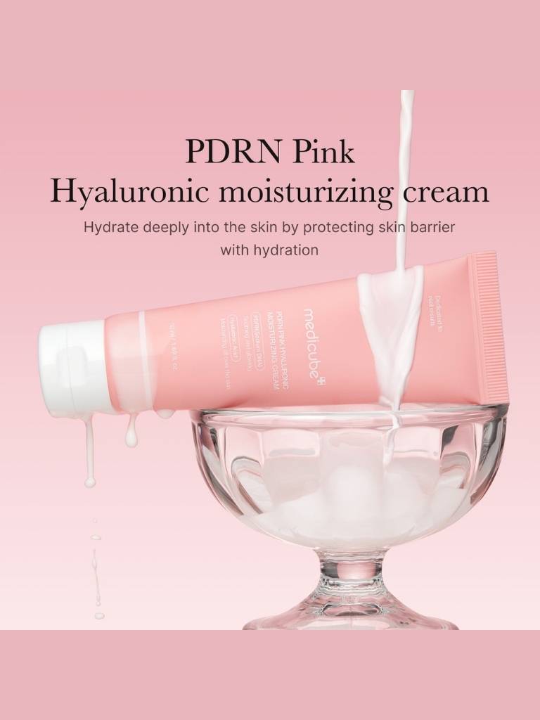 Pink hyaluronic moisturizing cream being poured into a glass bowl on a pink background with text about the product.