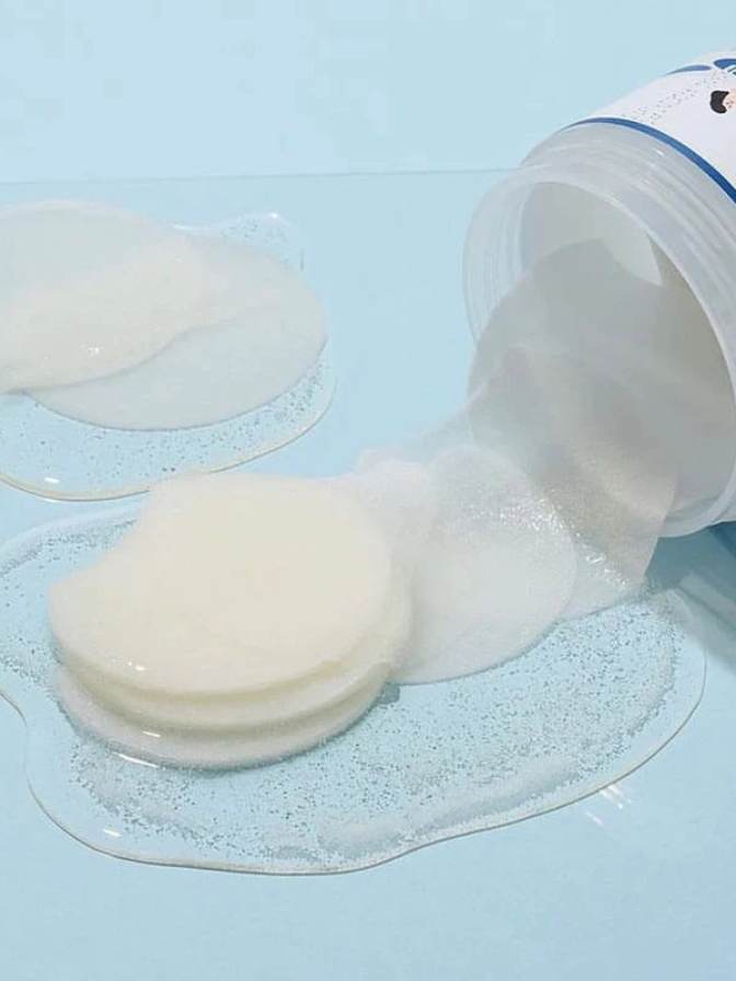 White gel being poured from a container onto a blue surface