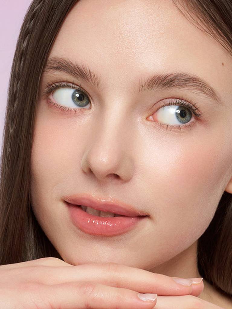Close-up of a person with a soft pink lip color