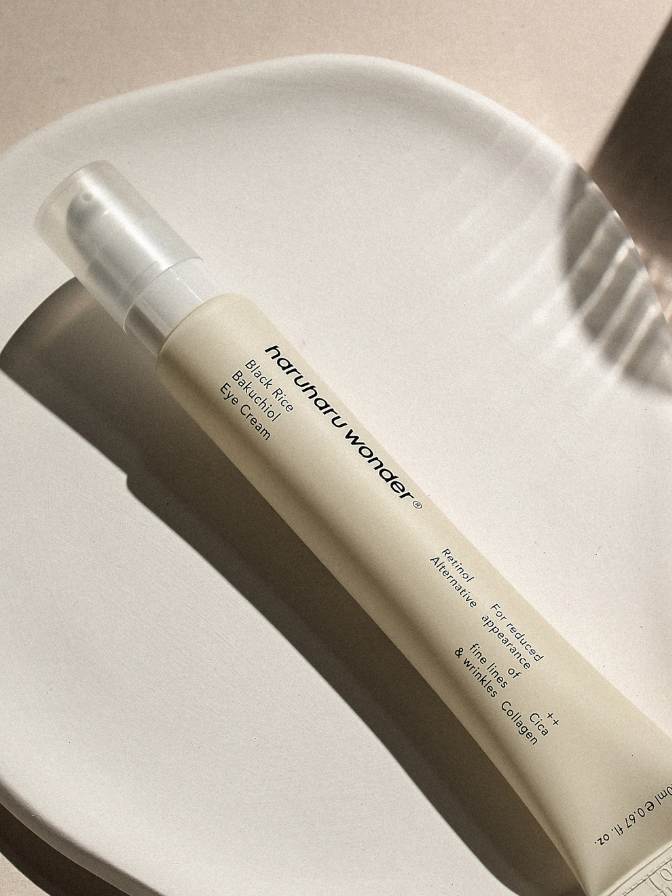 Eye cream bottle with 'nerunaru wonder' branding on a beige background