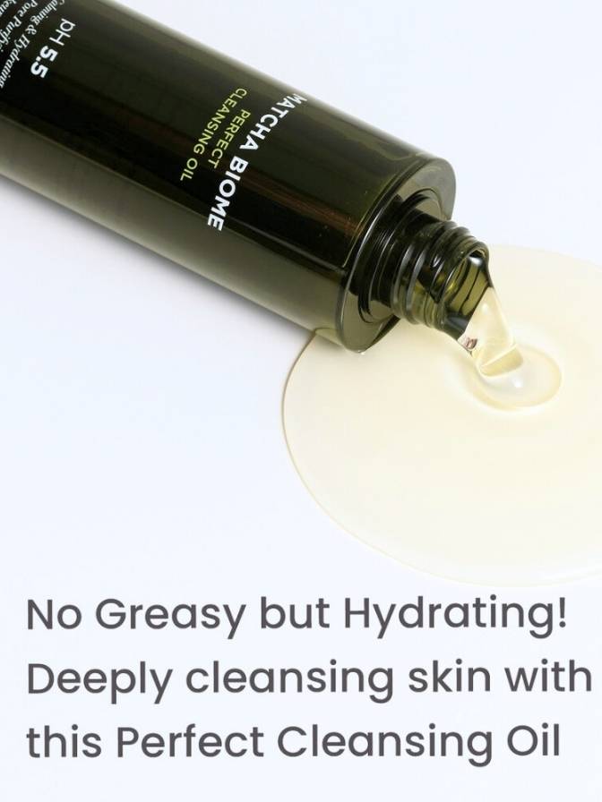 Cleansing oil bottle with droplet of oil on white background