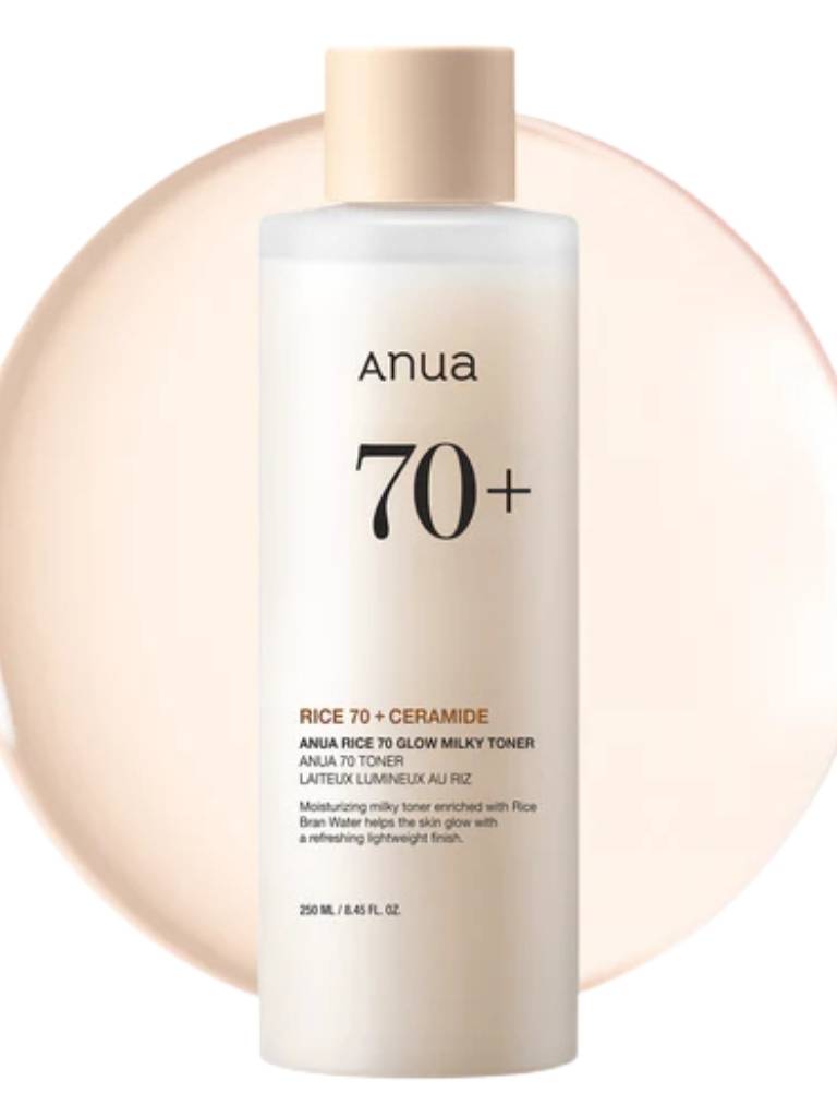 Anua 70+ toner bottle with beige cap on a light pink background