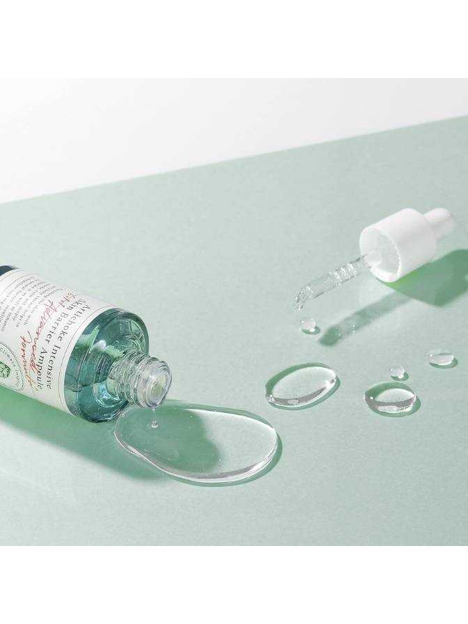 Skincare product with dropper on a light green background