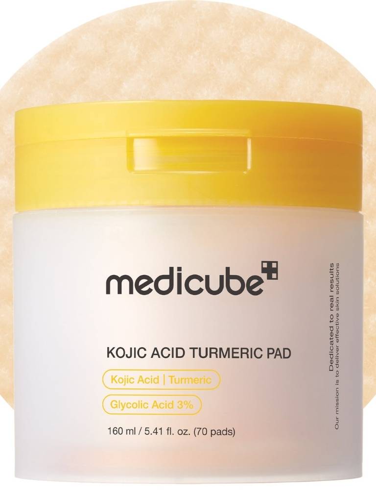 Medicube Kojic Acid Turmeric Pad packaging with a yellow lid on a light background