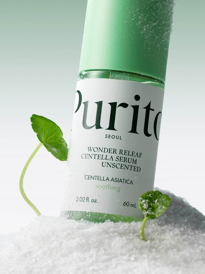 Purito Wonder Releaf Centella Serum bottle with green leaves on a white background
