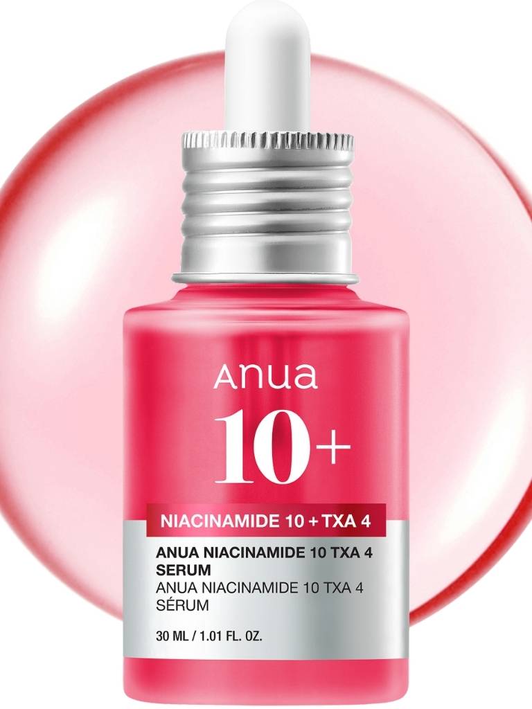 Pink serum bottle with dropper labeled 'Anua' on a white background