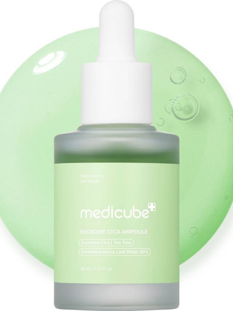 Medicube serum bottle with dropper on a green background