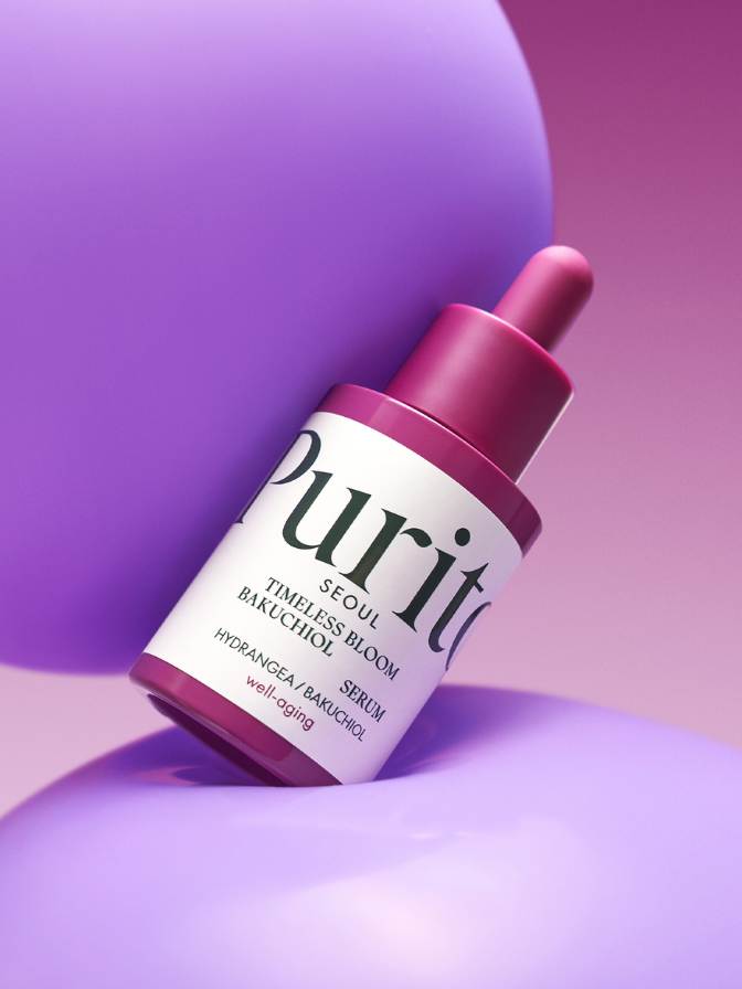 Skincare serum bottle with 'Puriti' label on a purple background