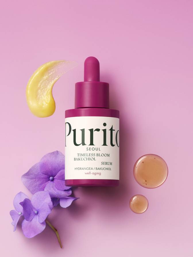 Purito skincare serum bottle with floral elements on a pink background