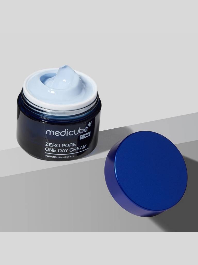 Jar of Medicube Zero Pore One Day Cream with blue cream on a gray background
