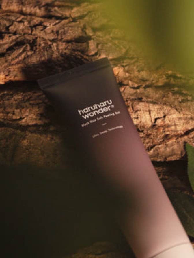 Black tube of 'haruharu wonder' product on a wooden surface