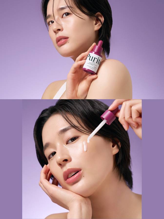 Woman applying skincare product to face with a purple background