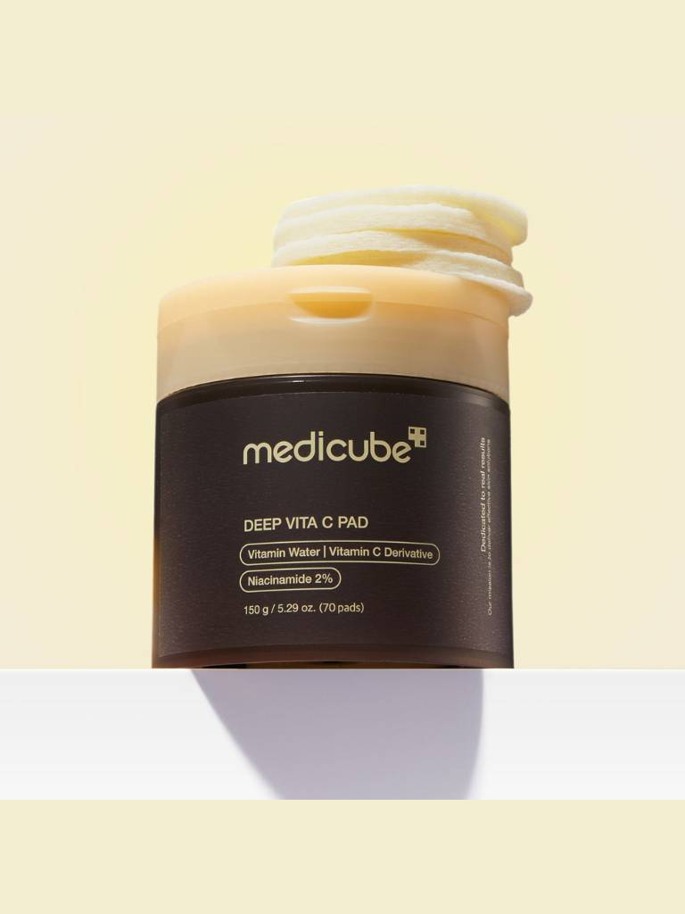 Medicube Deep Vita C Pad jar on a light yellow background