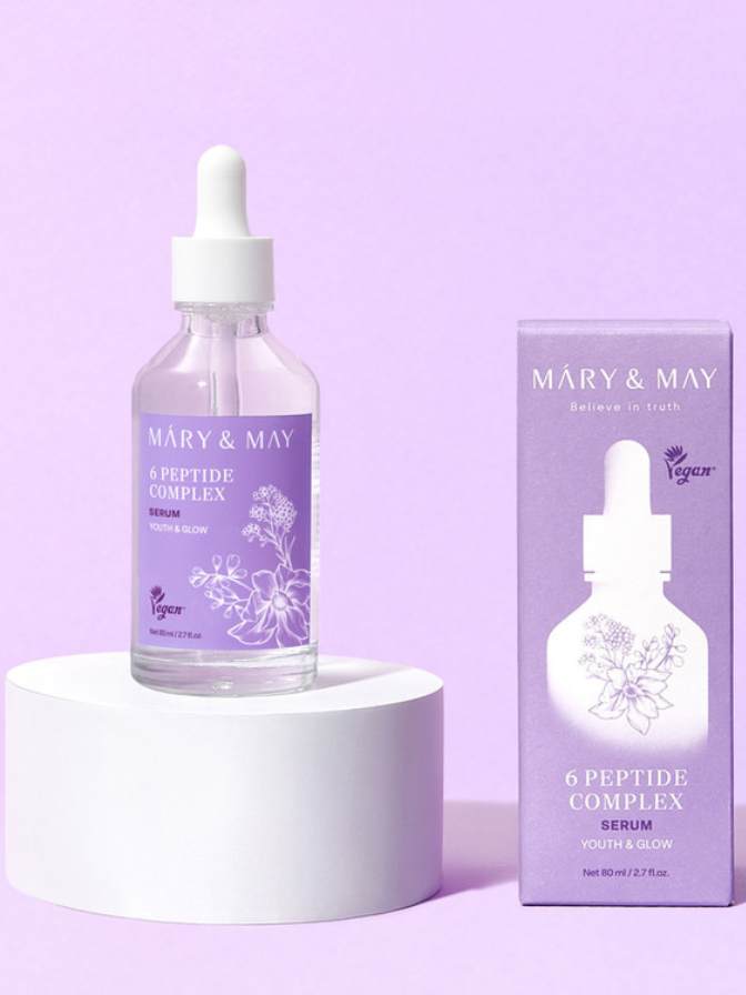 Mary & May 6 Peptide Complex serum bottle and packaging on a purple background