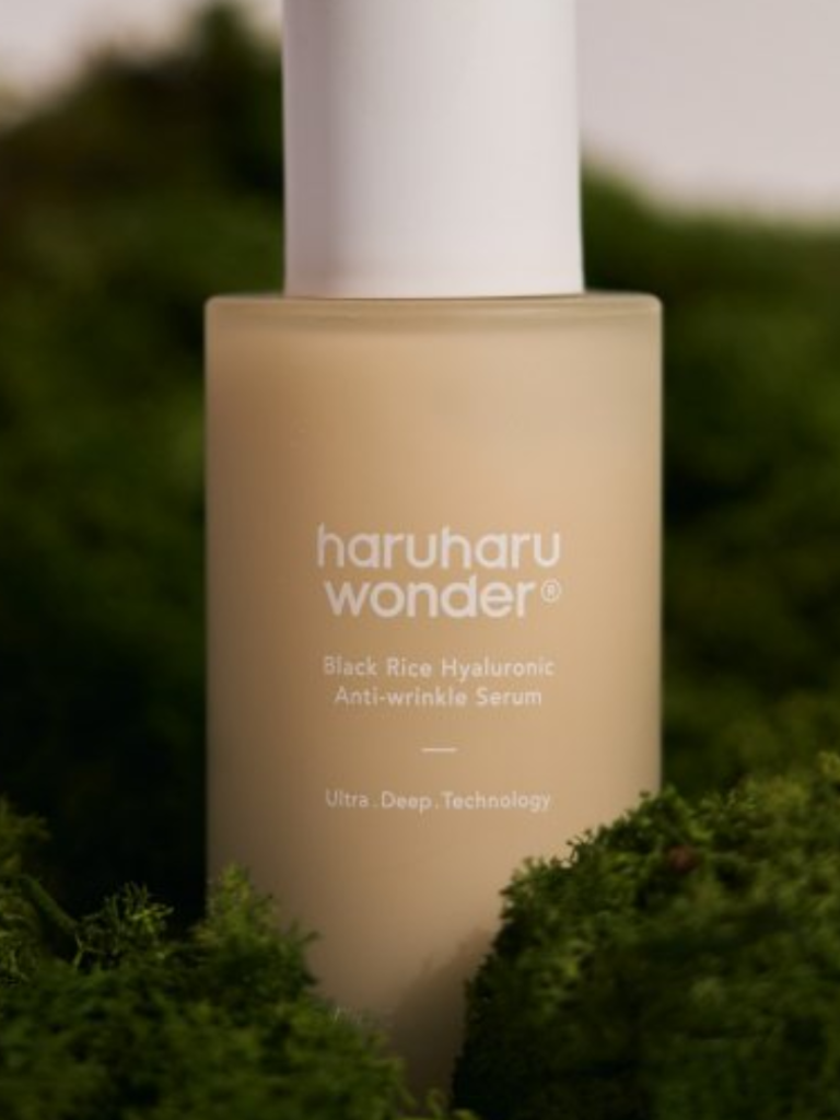 Haruharu Wonder serum bottle with green foliage in the background