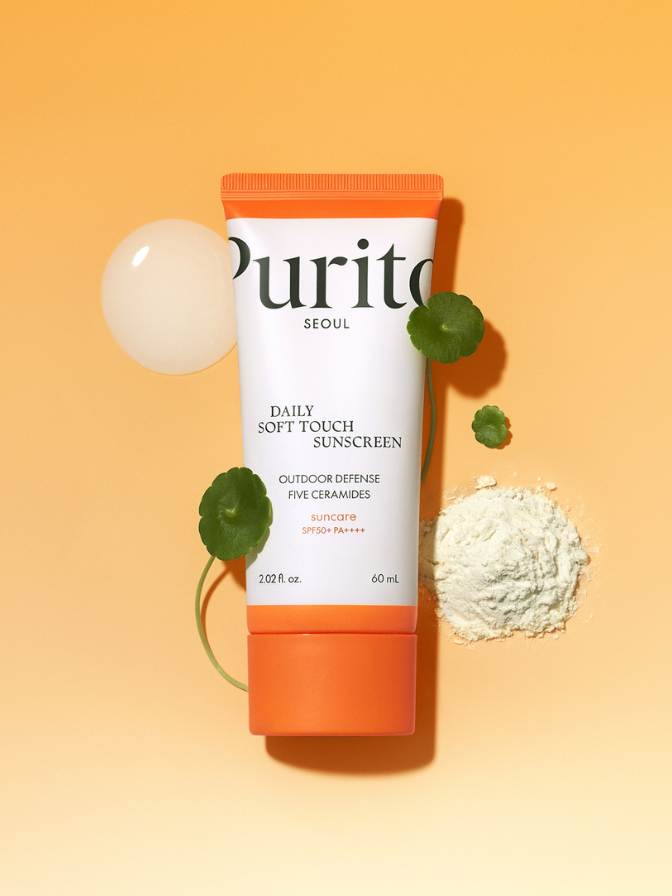 Purito Daily Soft Touch Sunscreen tube on a yellow background