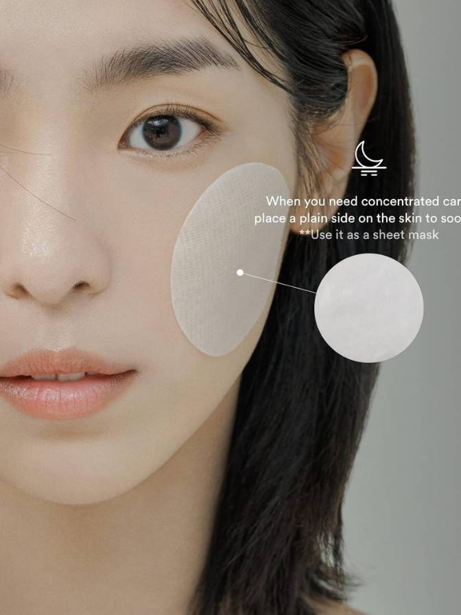 Close-up of a person wearing eye patches with instructions on how to use them.