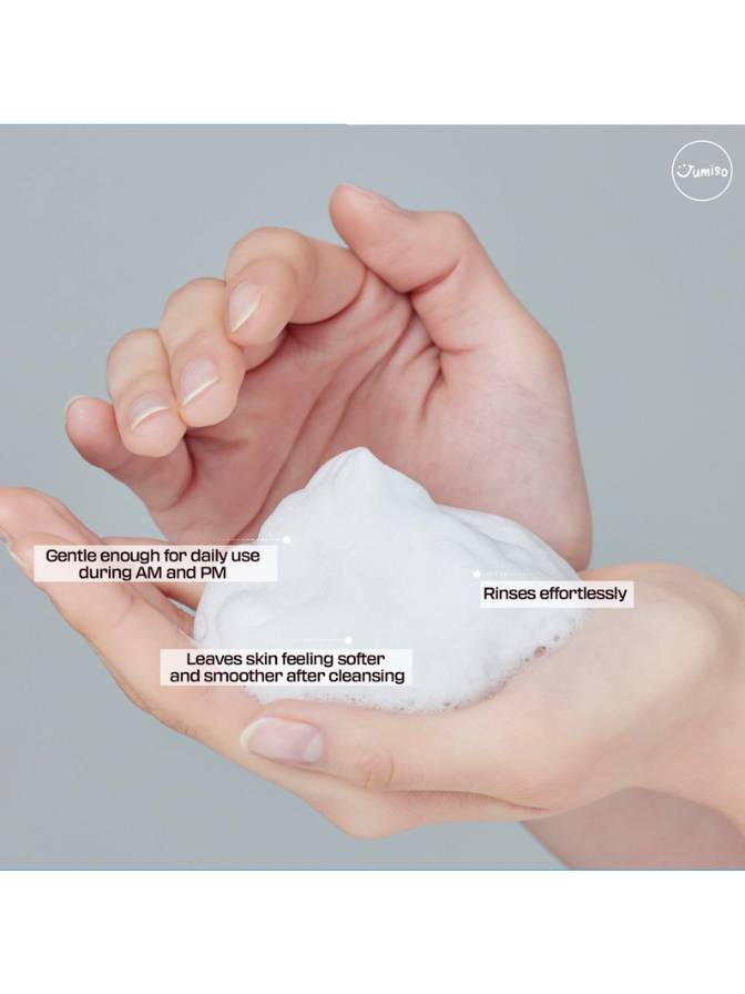 Hand holding a bar of soap with text on a gray background