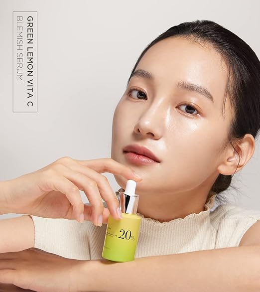 Woman holding a green skincare serum bottle with text on a light background