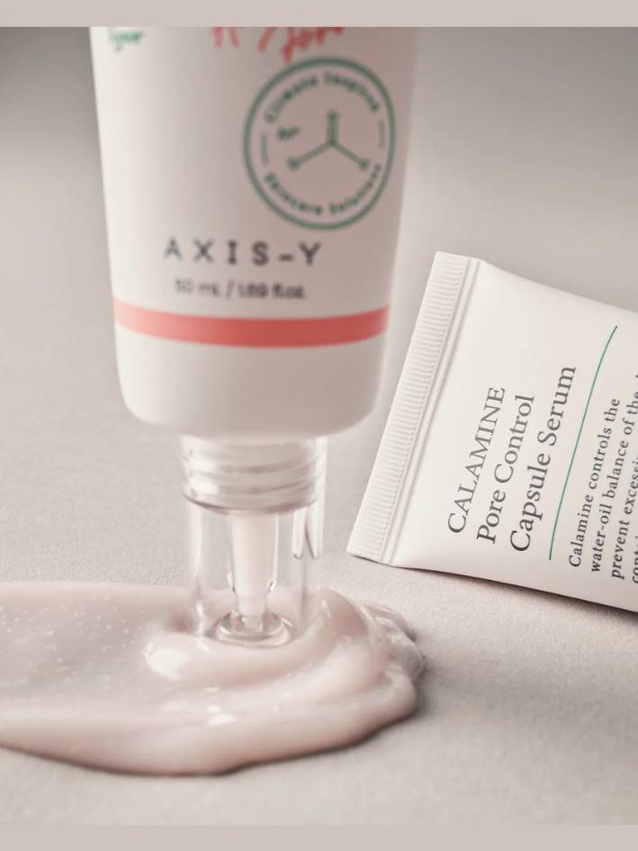  AXIS-Y skincare product with a droplet of serum on a neutral background
