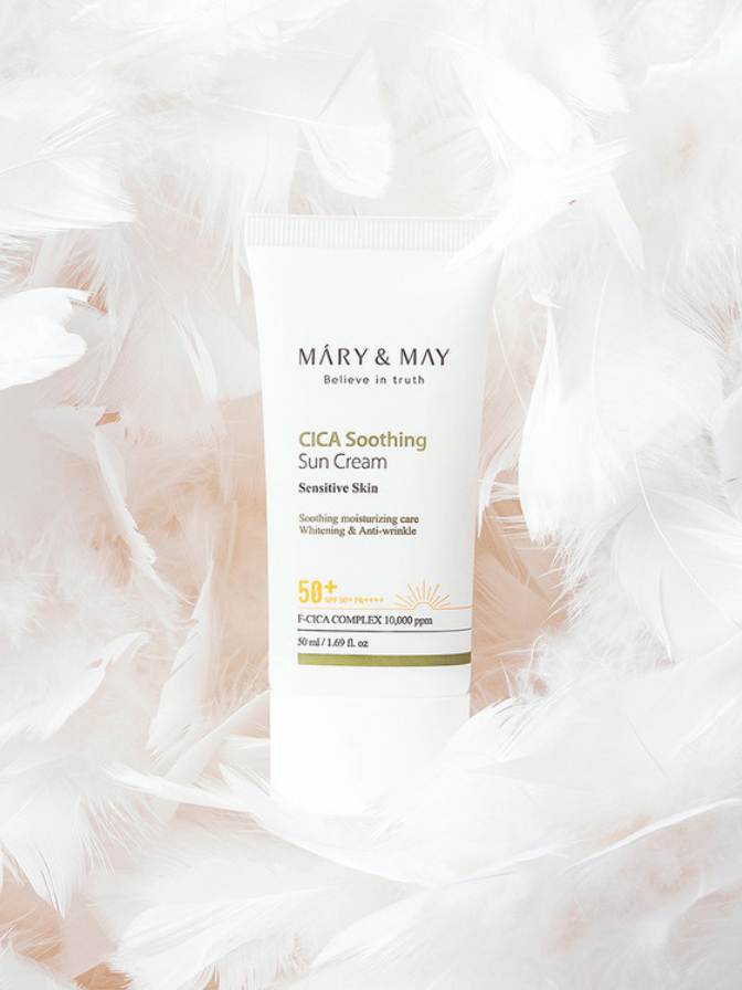 Mary & May CICA Soothing Sun Cream bottle on a soft pink background