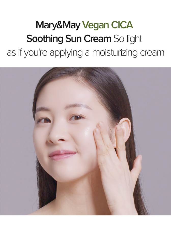 Woman applying cream to her face with Mary&May Vegan CICA Soothing Sun Cream text above.