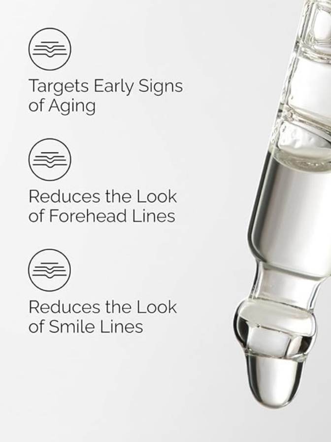Skincare serum bottle with text highlighting its benefits on a light gray background