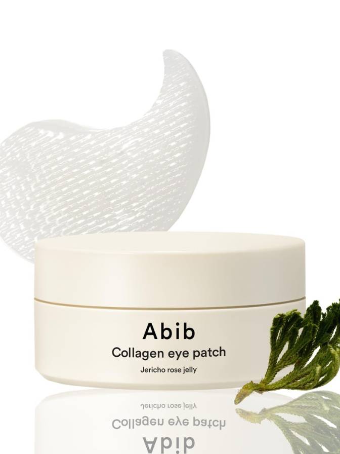Jar of Abib Collagen eye patch with a white crescent moon and green leaf on a reflective surface.