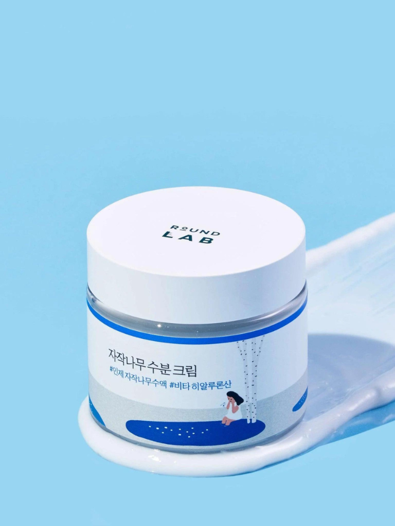 Skincare cream jar with 'ROUND LAB' branding on a blue background