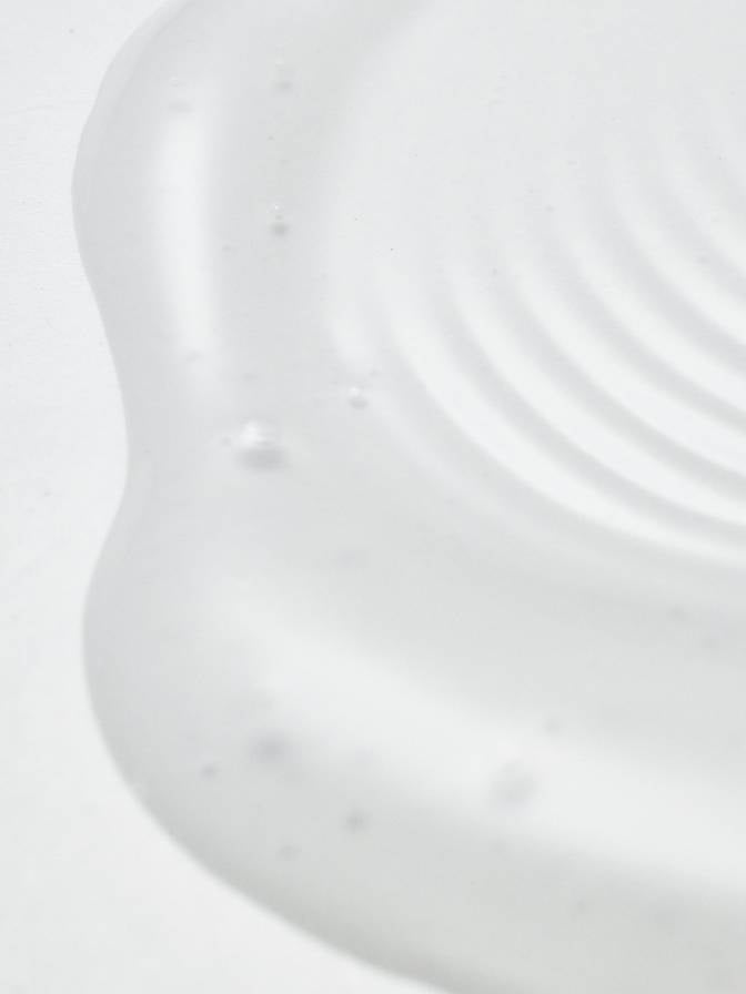 Close-up of a white cream or lotion with a marble background
