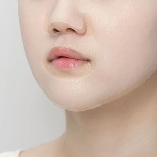 Close-up of a person's face with a focus on the skin texture of Anua Heartleaf 77% Soothing Sheet Mask 