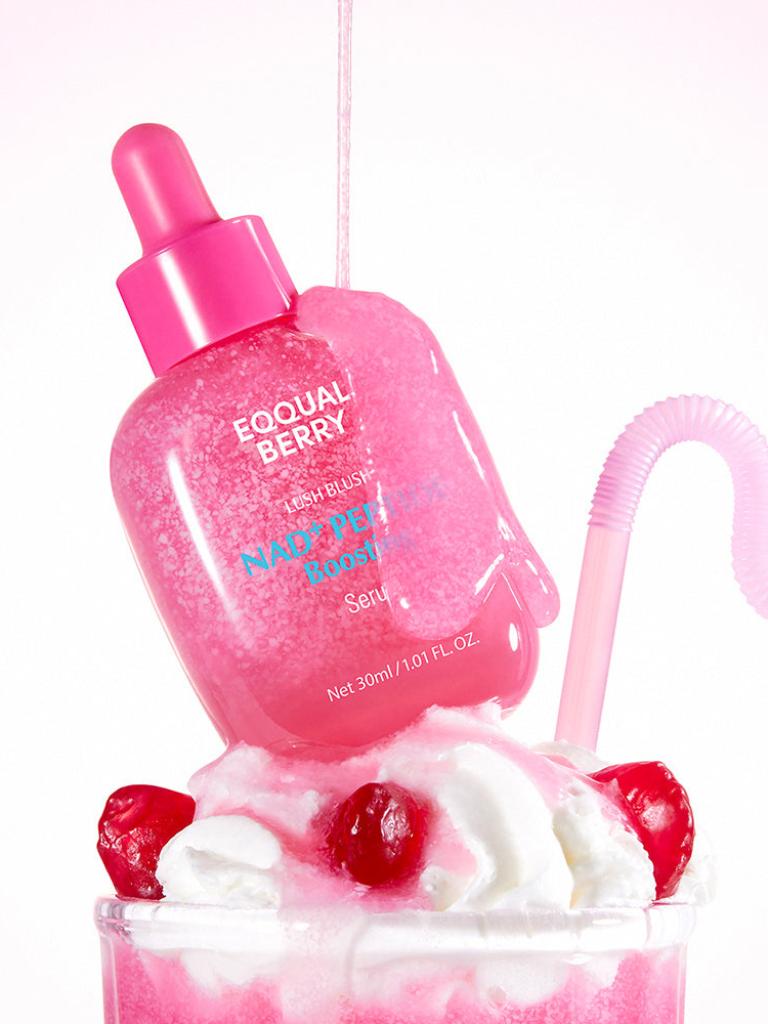 Pink bottle labeled 'Eqqual Berry' with a cherry and whipped cream on a white background