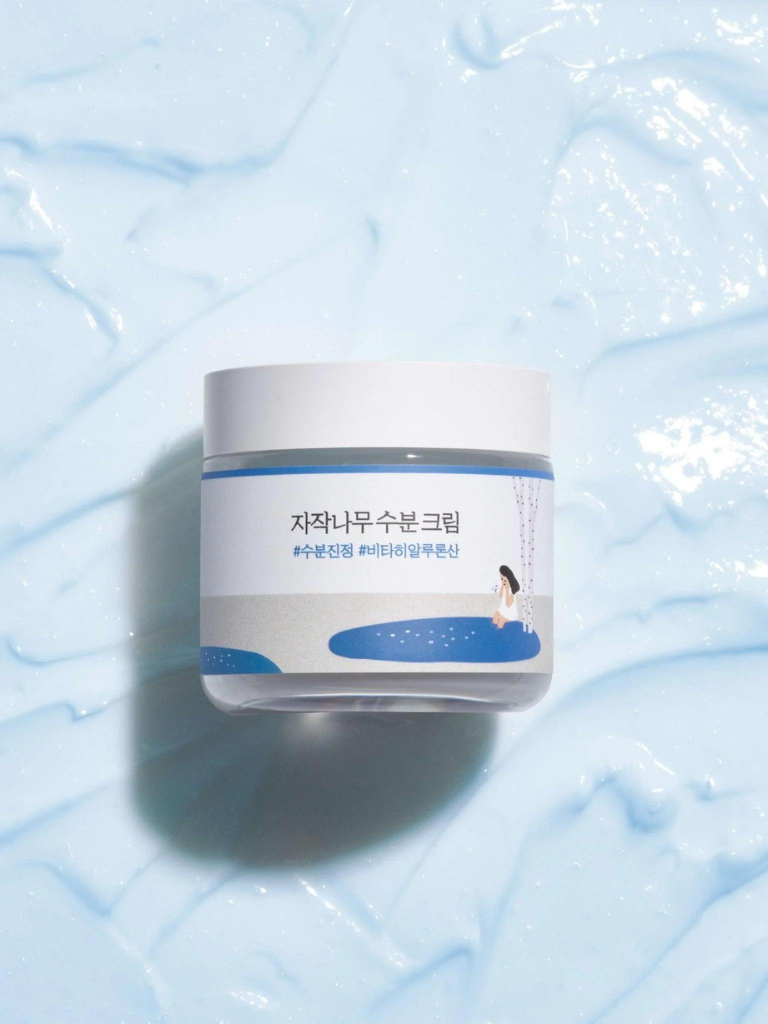 Jar of cream on a textured blue background