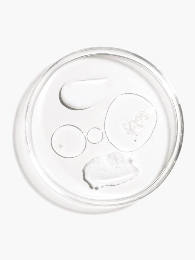 Clear plastic lid with water droplets on a white background