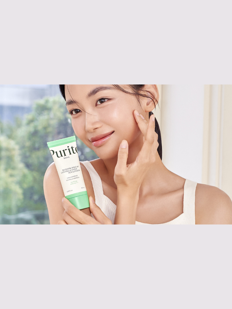 Woman holding a Purito skincare product with a blurred outdoor background