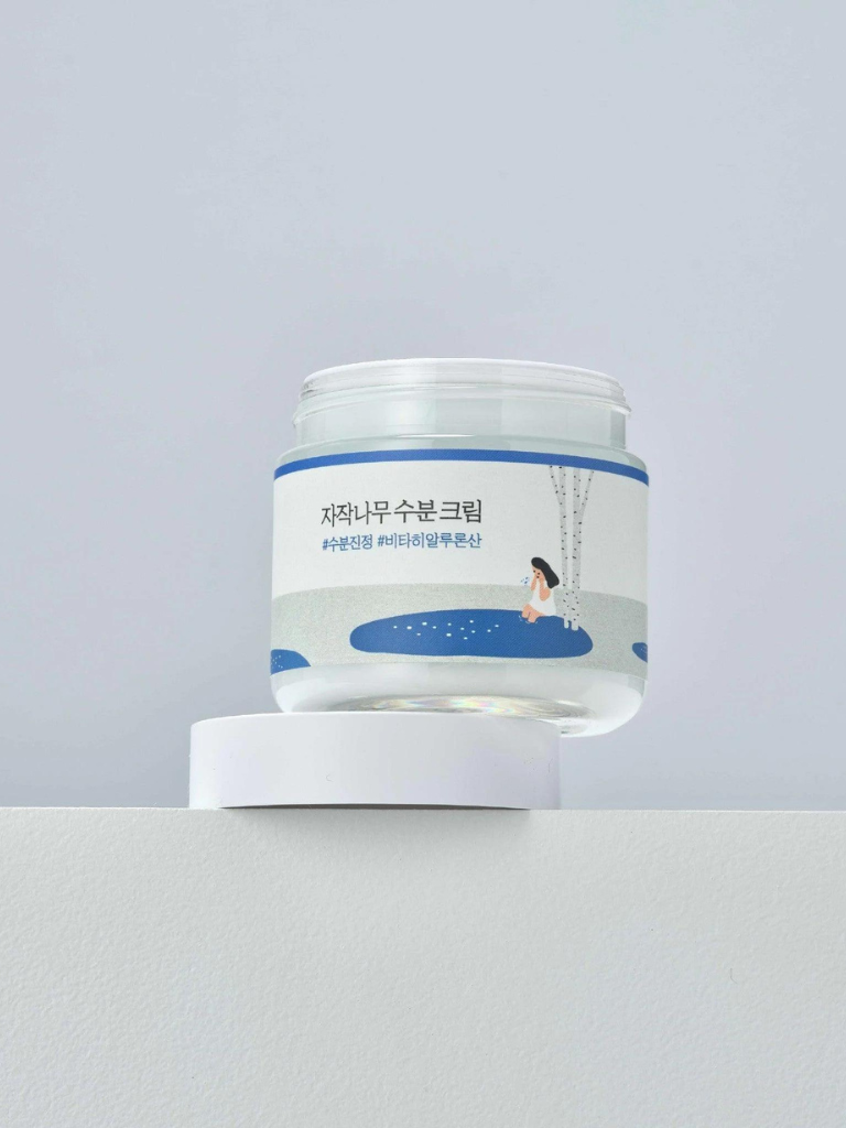 Jar of cream with a blue label on a gray background