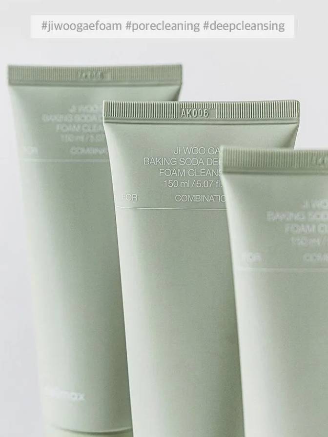 Three green skincare tubes with text on a light gray background