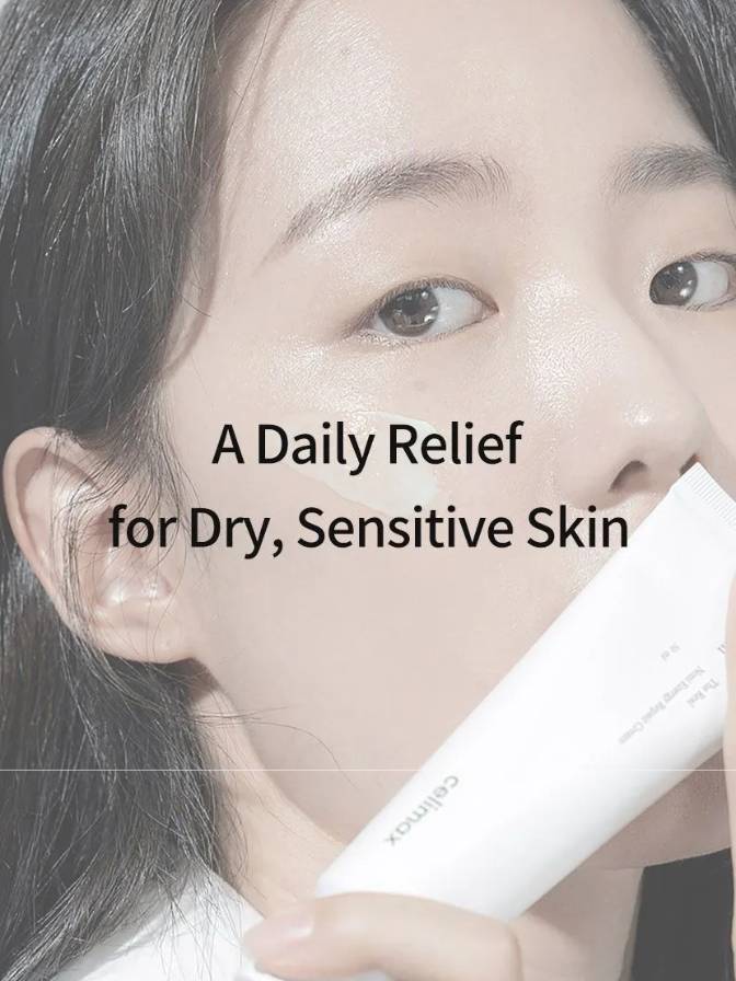 Person holding a white tube with text 'A Daily Relief for Dry, Sensitive Skin' on a light background