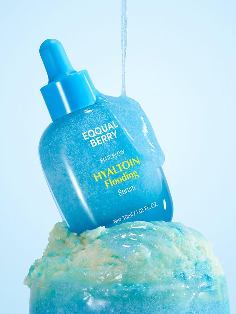 Blue serum bottle with dropper labeled 'EQual Berry' on a light blue background