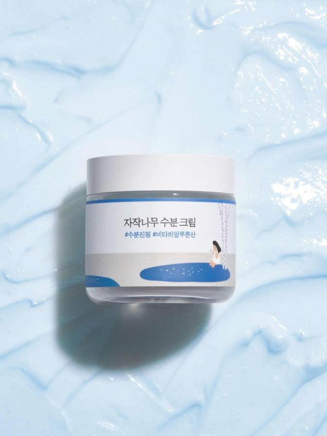 Skincare cream jar on a textured blue background