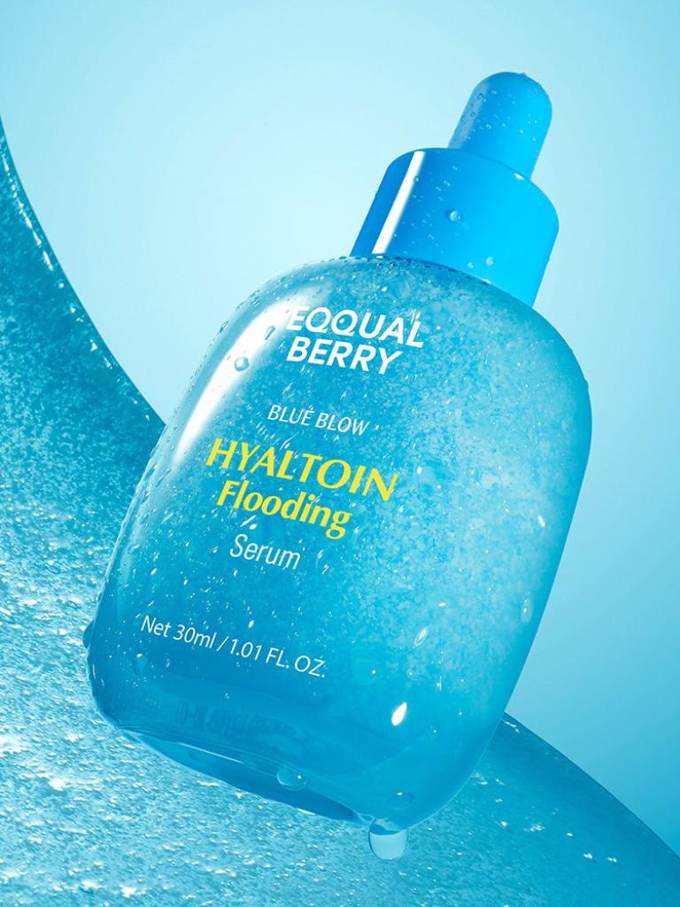 Blue bottle of Equal Berry Hyaltoin Flooding Serum with a dropper on a blue background
