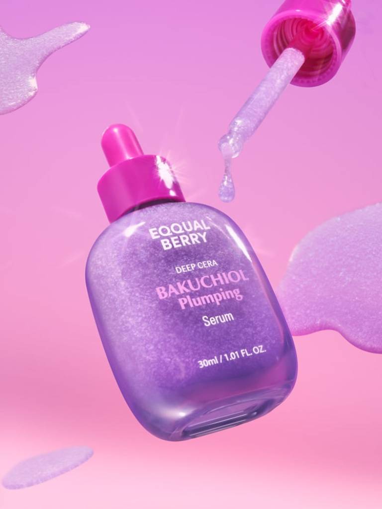 Purple serum bottle with pink dropper on a pink background
