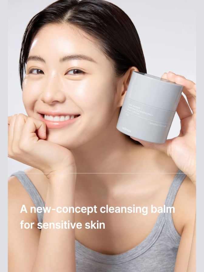 Woman holding a small container with text about a new-concept cleansing balm for sensitive skin.