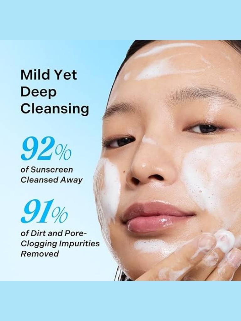 Person cleansing their face with text highlighting skincare product effectiveness on a blue background