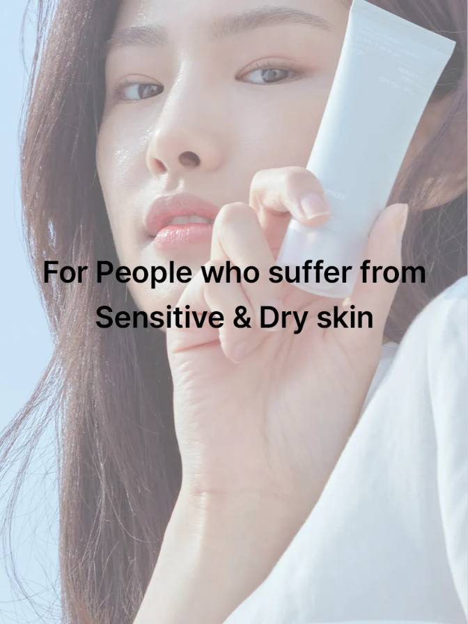 Person holding a sheet of paper with text 'For People who suffer from Sensitive & Dry skin' on a light background