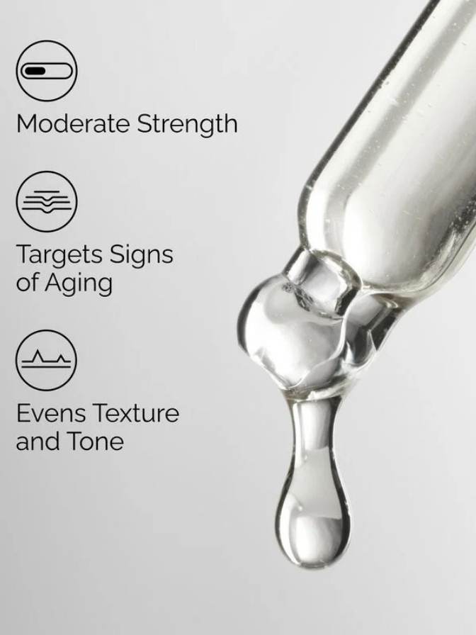 Skincare dropper with a drop of liquid on a light gray background, featuring text about product benefits.