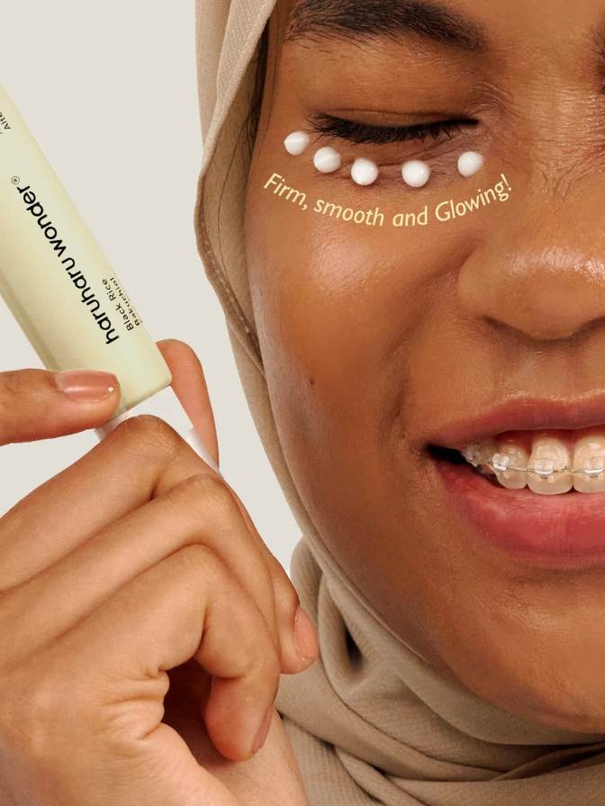 Woman applying a skincare product with text 'Firm, smooth and glowing!' on her face.