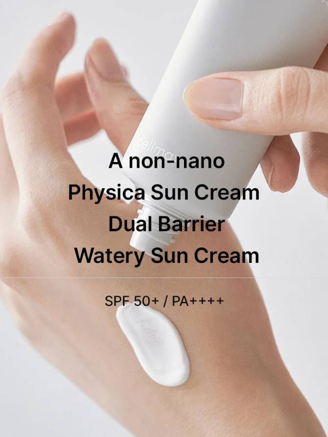 Hand applying a tube of Physica Sun Cream Dual Barrier Watery Sun Cream on skin with text overlay.