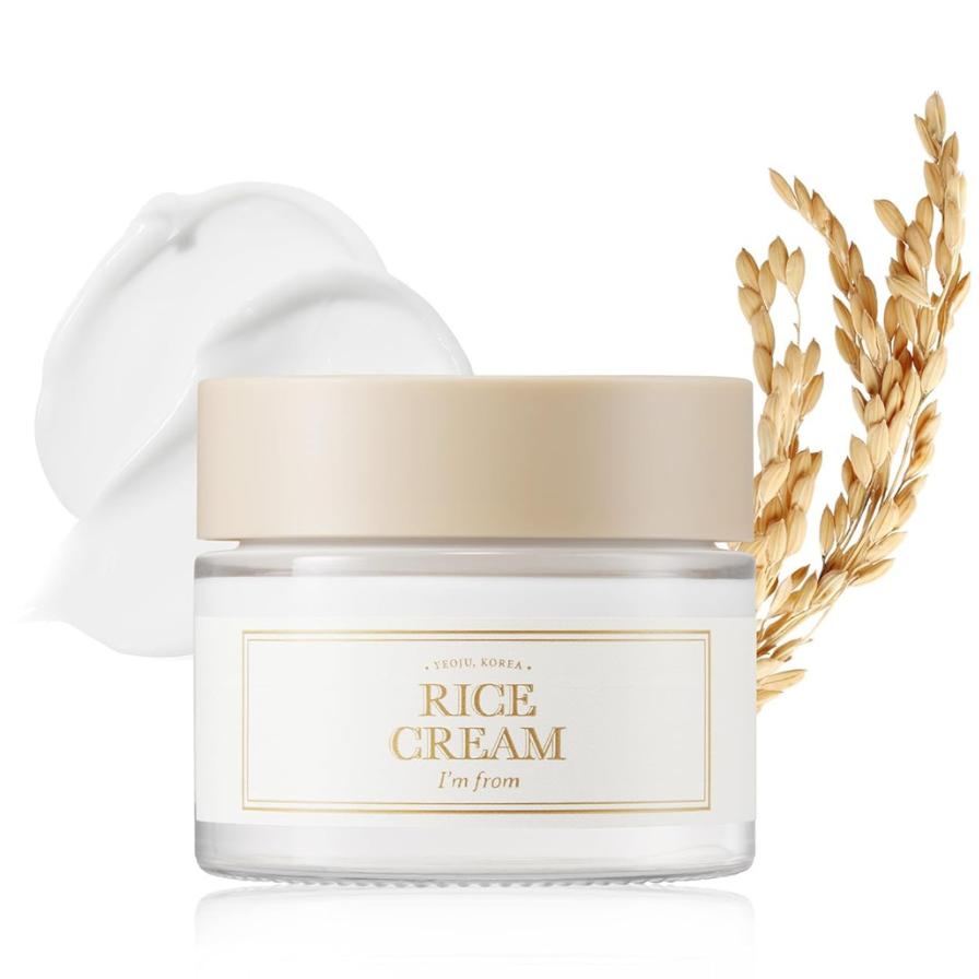 Jar of rice cream with a swatch of cream and wheat stalk on a white background