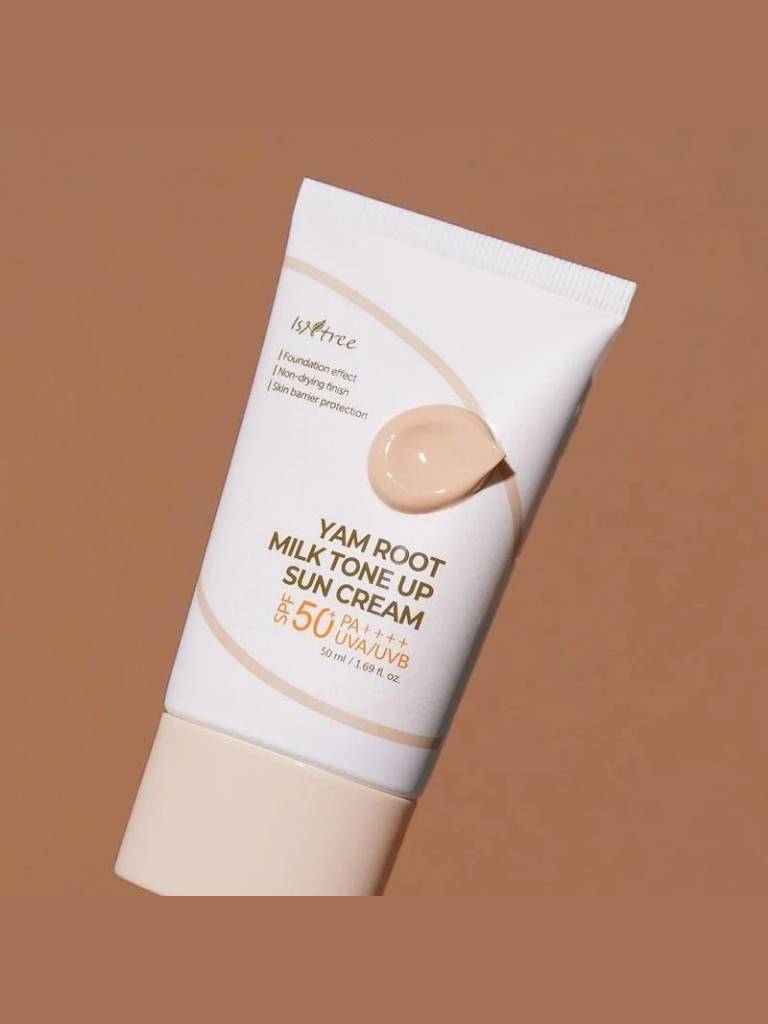 Yam root milk tone up sun cream tube on a brown background